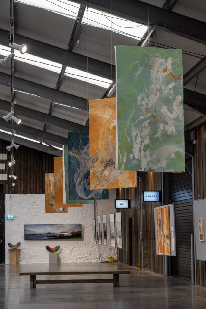 Hanging artworks in Space to Breathe: Land & Sea